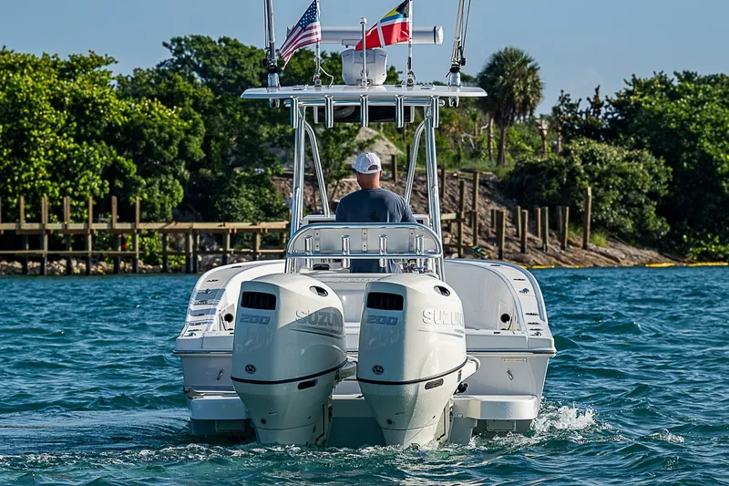 Slide: The Image of 2019 Ocean Master 296 boat with dual Suzuki engines cruising on a sunny day. - 4