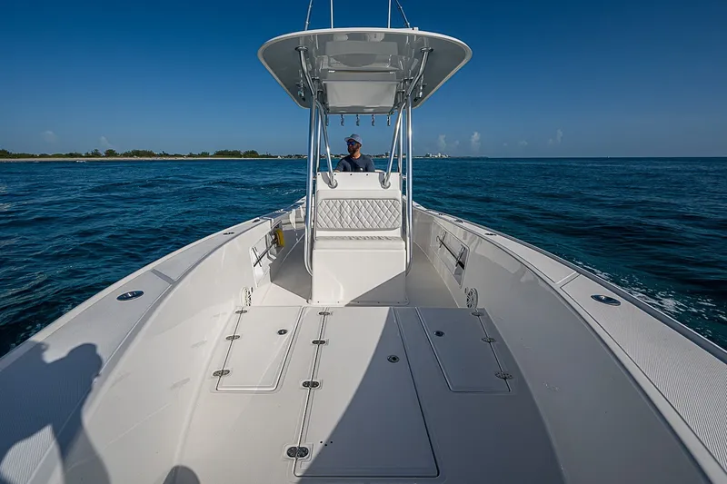 Slide: The Image of 2019 Ocean Master 296 boat cruising on open water under clear blue skies. - 8