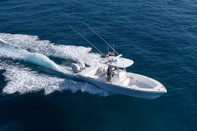 Slide: The Image of 2019 Ocean Master 296 boat cruising on open blue sea. - 22
