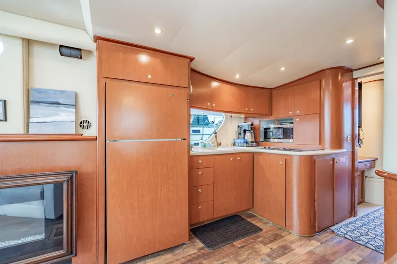 Slide: The Image of Luxurious 2003 Bluewater Yachts Custom 6000 kitchen with wood cabinetry and modern appliances. - 43