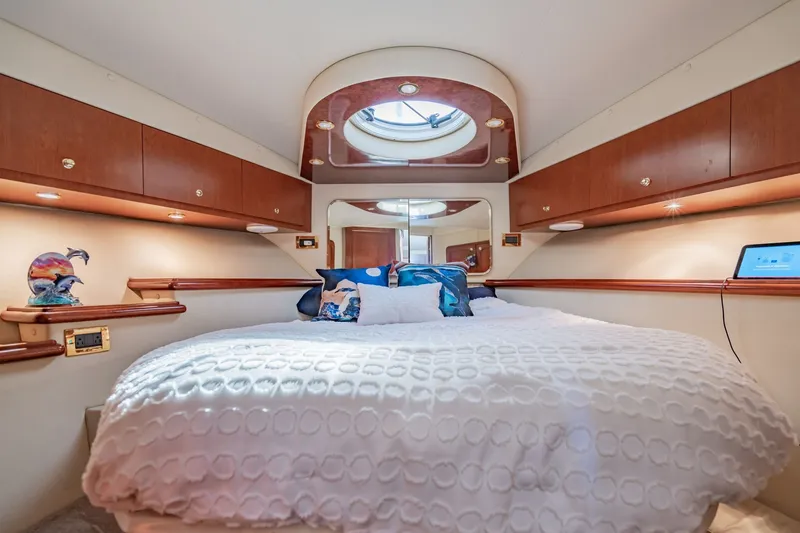 Slide: The Image of Luxurious bedroom interior of 2003 Bluewater Yachts Custom 6000 with elegant wood cabinetry. - 52