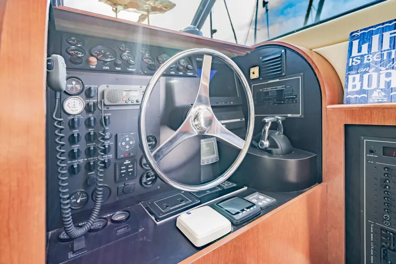 Slide: The Image of Control panel of a 2003 Bluewater Yachts Custom 6000 with steering wheel and gauges. - 36