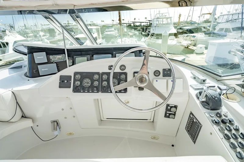 Slide: The Image of Cockpit of 2003 Bluewater Yachts Custom 6000 with steering wheel and navigation instruments. - 77