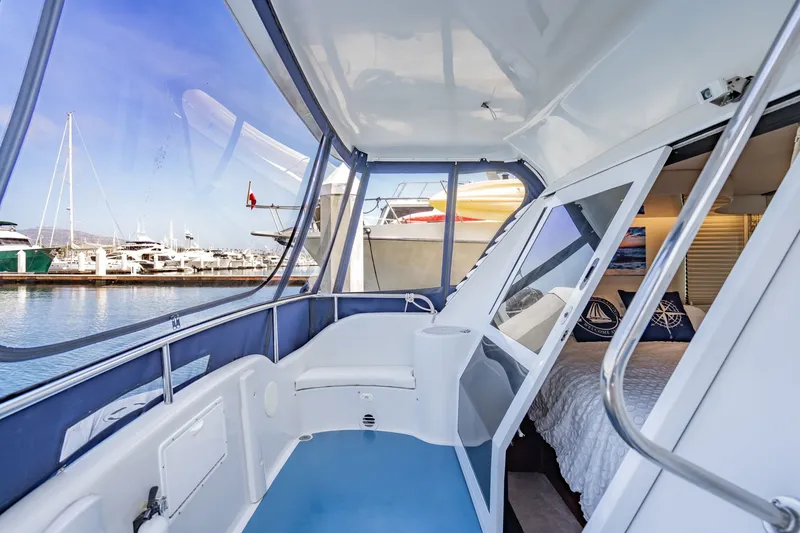 Slide: The Image of 2003 Bluewater Yachts Custom 6000 interior with marina view, showcasing luxury and comfort. - 70
