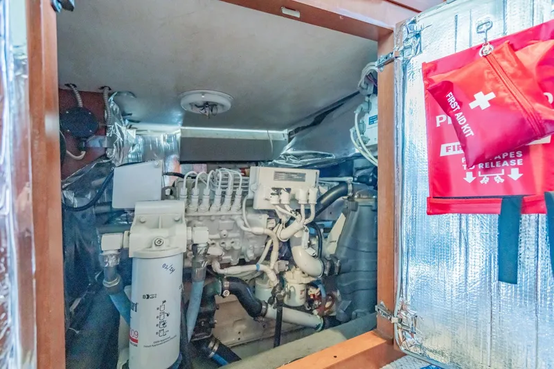 Slide: The Image of Engine room of 2003 Bluewater Yachts Custom 6000 with first aid kit visible. - 89