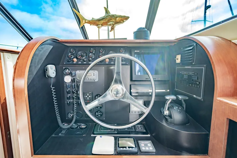 Slide: The Image of Helm of 2003 Bluewater Yachts Custom 6000 with steering wheel and control panel. - 35