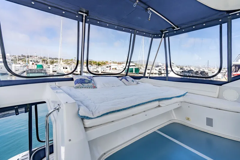Slide: The Image of Luxurious 2003 Bluewater Yachts Custom 6000 interior with panoramic marina views. - 9