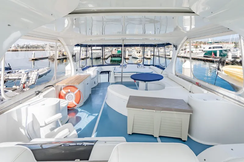 Slide: The Image of Spacious interior of 2003 Bluewater Yachts Custom 6000, featuring seating and marina view. - 81