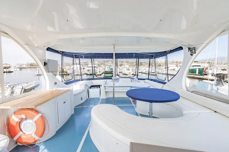 Slide: The Image of Spacious interior of 2003 Bluewater Yachts Custom 6000 with panoramic marina views. - 6