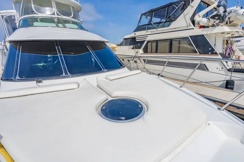 Slide: The Image of 2003 Bluewater Yachts Custom 6000 docked, showcasing sleek design and spacious deck. - 24