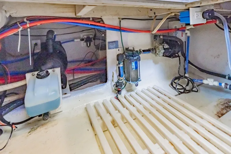 Slide: The Image of Engine room of 2003 Bluewater Yachts Custom 6000 with visible wiring and components. - 83