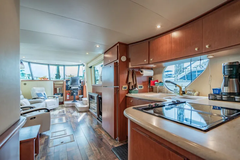 Slide: The Image of Luxurious interior of 2003 Bluewater Yachts Custom 6000 with modern kitchen and seating area. - 45