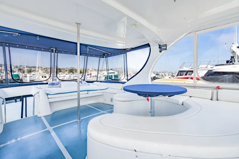 Slide: The Image of Spacious interior of 2003 Bluewater Yachts Custom 6000 with panoramic marina views. - 8