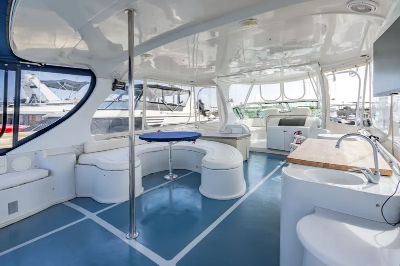 Slide: The Image of Spacious interior of 2003 Bluewater Yachts Custom 6000 with modern seating and kitchenette. - 15