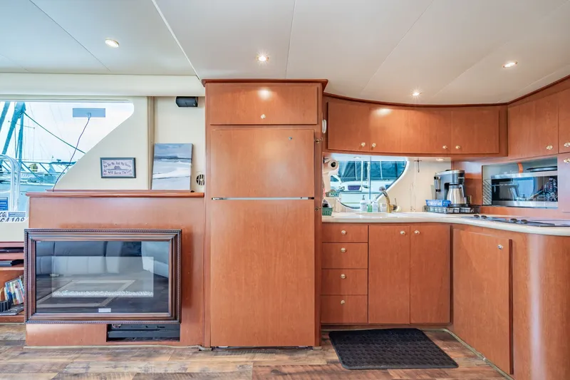 Slide: The Image of Luxurious 2003 Bluewater Yachts Custom 6000 interior with modern kitchen and cozy fireplace. - 42