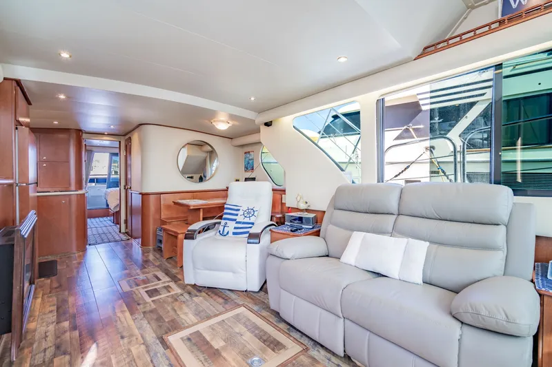Slide: The Image of Luxurious interior of 2003 Bluewater Yachts Custom 6000 with plush seating and elegant wood finishes. - 26