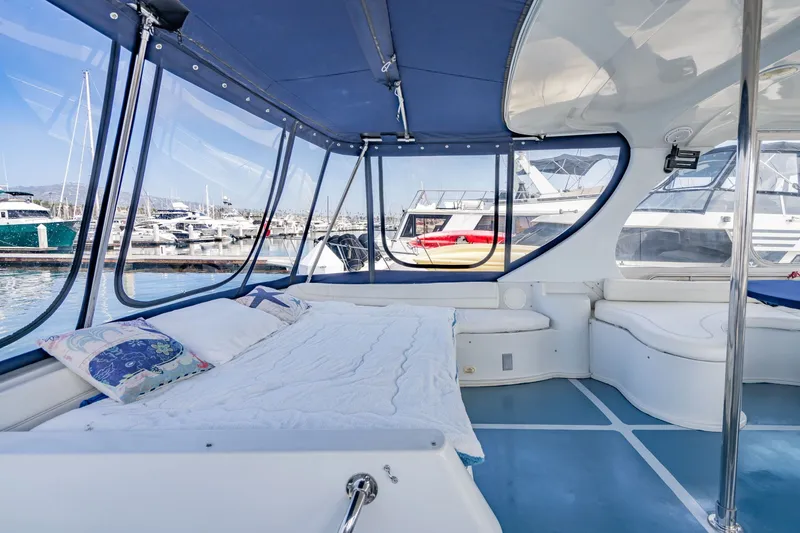 Slide: The Image of Interior view of 2003 Bluewater Yachts Custom 6000, featuring a cozy seating area. - 14
