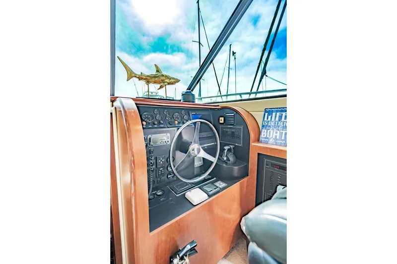 Slide: The Image of Helm of 2003 Bluewater Yachts Custom 6000 with steering wheel and control panel. - 34