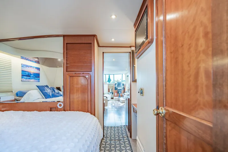 Slide: The Image of Luxurious interior of 2003 Bluewater Yachts Custom 6000, featuring elegant wood finishes and cozy bedroom. - 62