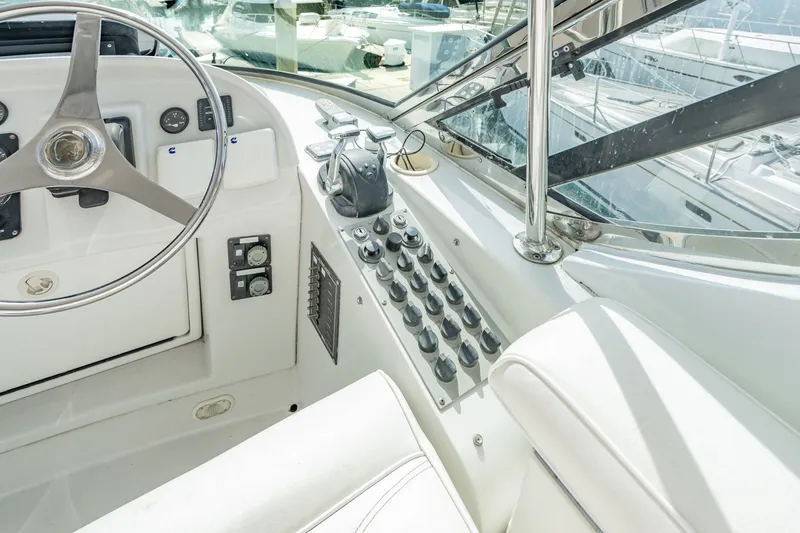 Slide: The Image of Helm of 2003 Bluewater Yachts Custom 6000 with steering wheel and control panel. - 78