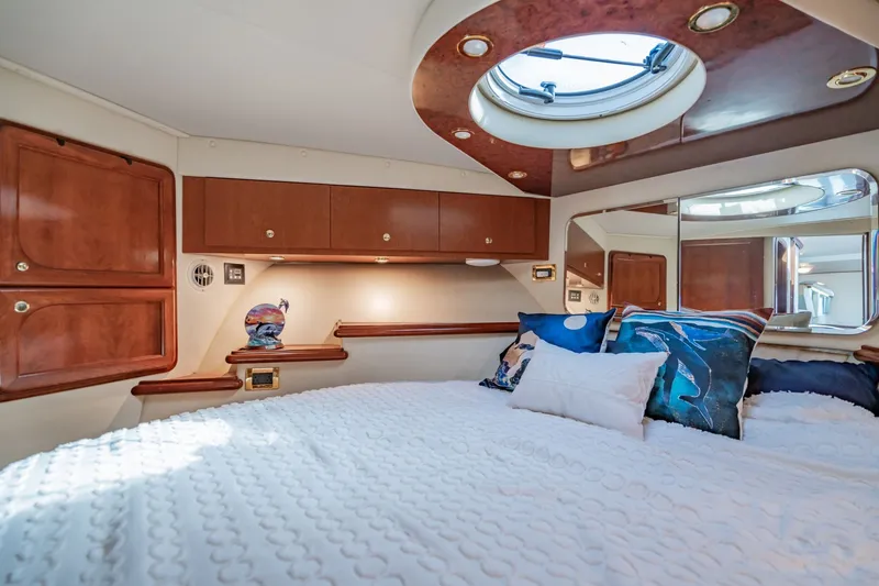 Slide: The Image of Luxurious cabin interior of 2003 Bluewater Yachts Custom 6000 with plush bedding and elegant wood finishes. - 53