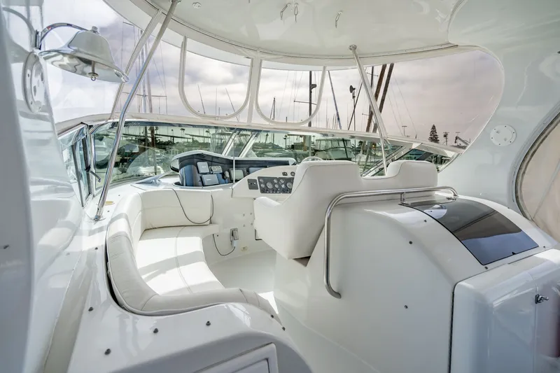 Slide: The Image of Luxurious 2003 Bluewater Yachts Custom 6000 interior with sleek white seating and control panel. - 74