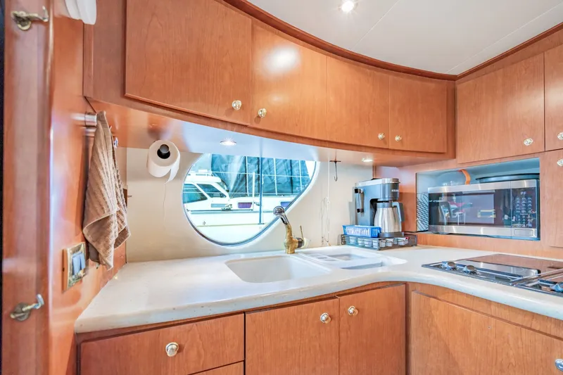 Slide: The Image of Luxurious kitchen interior of 2003 Bluewater Yachts Custom 6000 with modern appliances and wood cabinetry. - 41