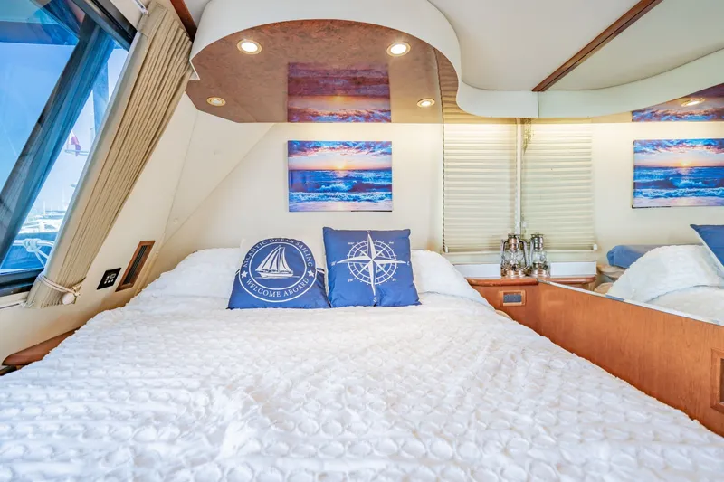 Slide: The Image of Luxurious bedroom interior of 2003 Bluewater Yachts Custom 6000 with nautical-themed decor. - 60