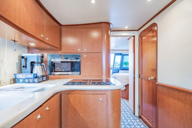 Slide: The Image of Luxurious kitchen interior of 2003 Bluewater Yachts Custom 6000 with modern appliances and wood cabinetry. - 40