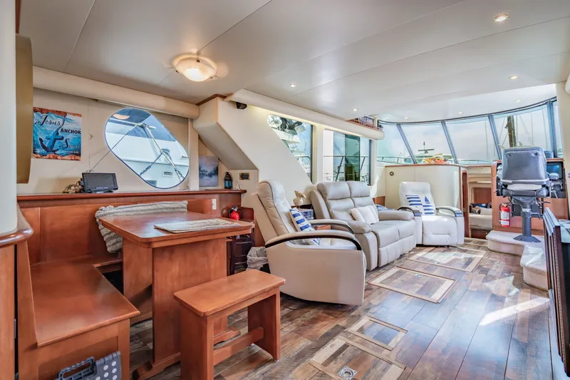 Slide: The Image of Luxurious interior of 2003 Bluewater Yachts Custom 6000 with plush seating and wooden accents. - 46