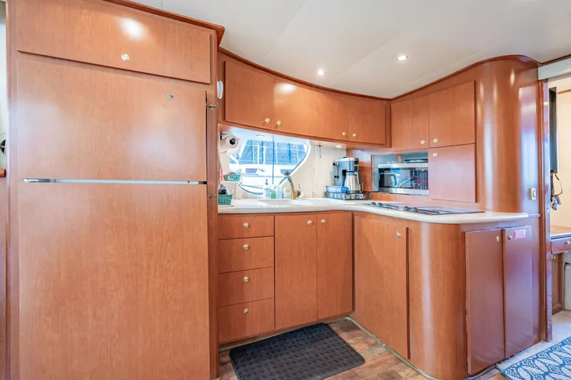 Slide: The Image of Luxurious kitchen interior of 2003 Bluewater Yachts Custom 6000 with wood cabinetry and modern appliances. - 39