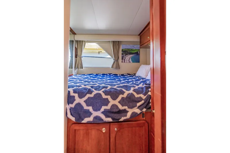 Slide: The Image of Cozy bedroom in 2003 Bluewater Yachts Custom 6000 with patterned bedding and window view. - 51