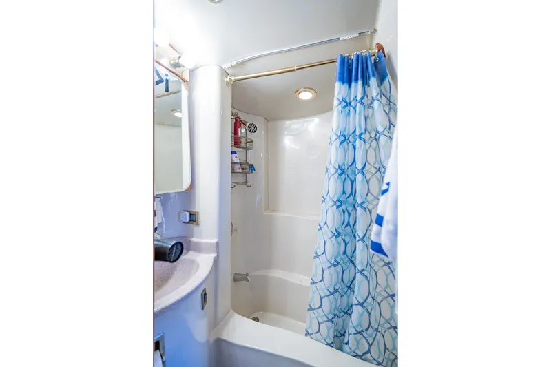 Slide: The Image of Bathroom with blue shower curtain in 2003 Bluewater Yachts Custom 6000. - 68