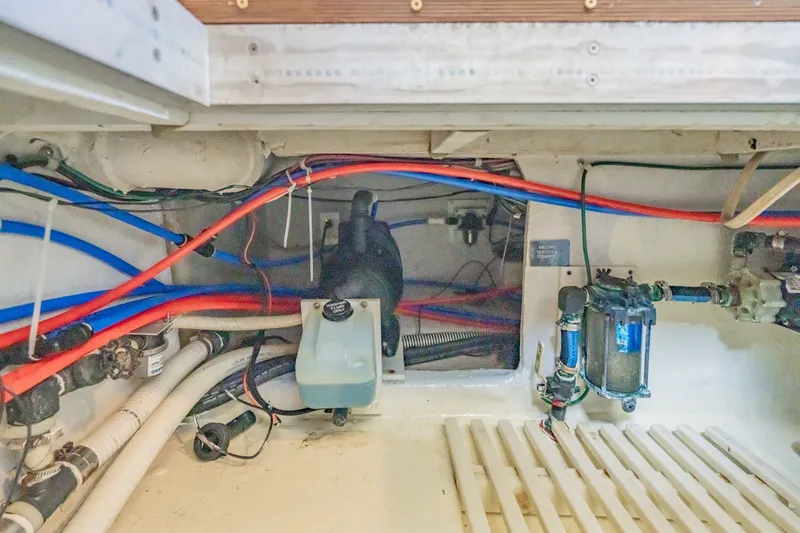 Slide: The Image of Engine room of 2003 Bluewater Yachts Custom 6000 with visible wiring and components. - 82