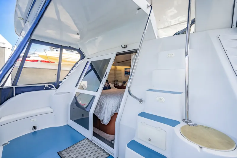 Slide: The Image of Interior view of 2003 Bluewater Yachts Custom 6000, featuring stairs and cozy cabin entrance. - 69