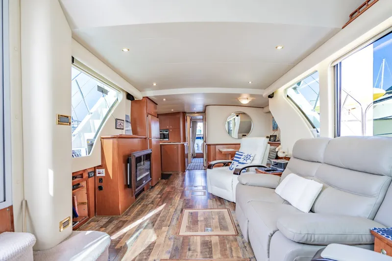Slide: The Image of Luxurious interior of 2003 Bluewater Yachts Custom 6000 with elegant seating and wood flooring. - 31