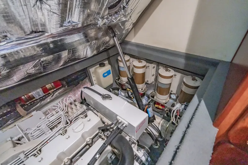 Slide: The Image of Engine room of 2003 Bluewater Yachts Custom 6000, showcasing mechanical components and systems. - 88