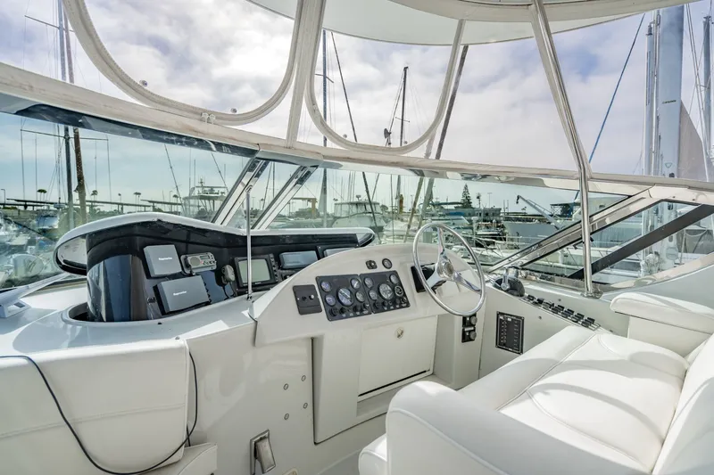 Slide: The Image of Cockpit of 2003 Bluewater Yachts Custom 6000, featuring modern navigation equipment and luxurious seating. - 75