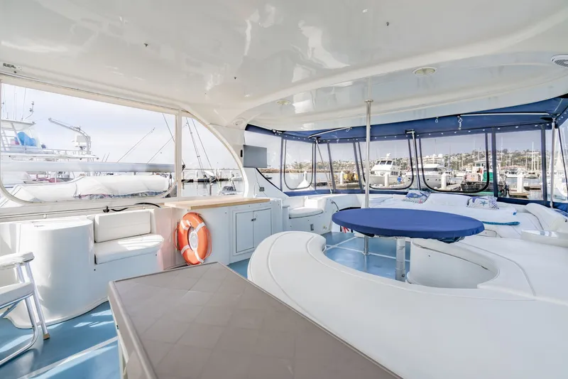 Slide: The Image of Luxurious interior of 2003 Bluewater Yachts Custom 6000, featuring spacious seating and panoramic windows. - 4