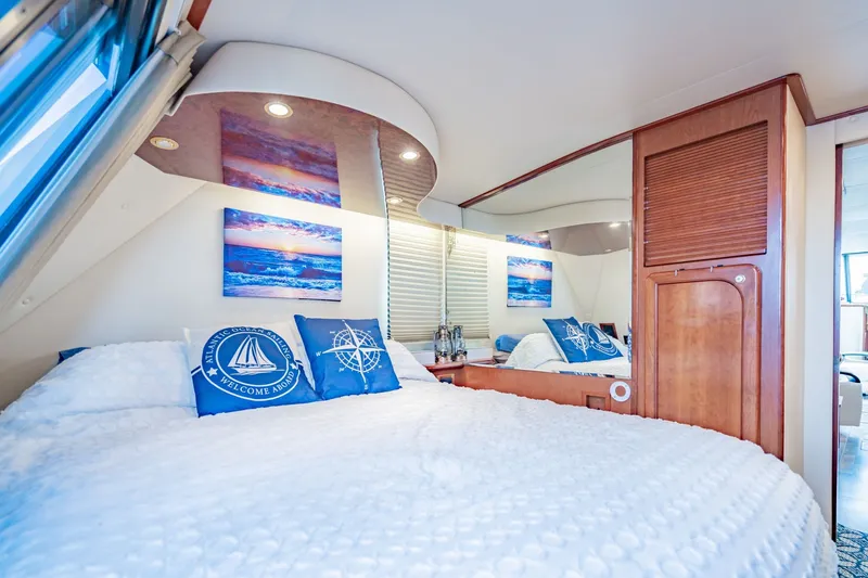 Slide: The Image of Luxurious bedroom interior of 2003 Bluewater Yachts Custom 6000, featuring nautical-themed decor. - 61