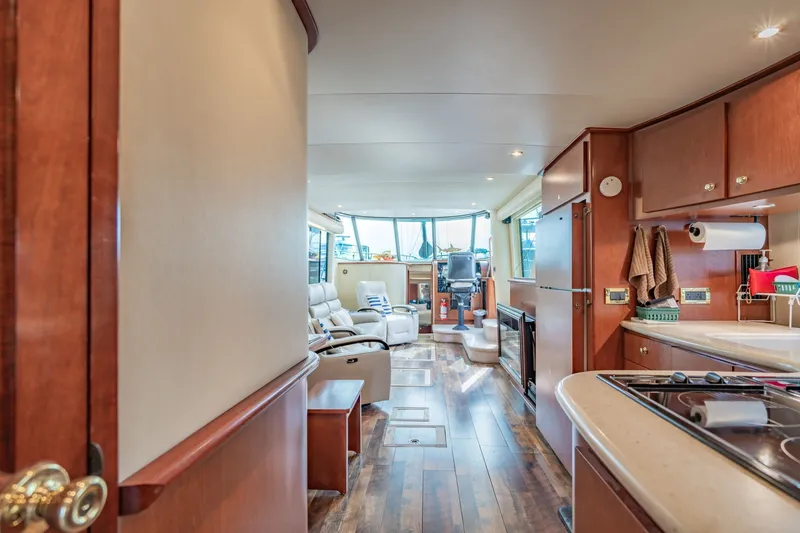 Slide: The Image of Luxurious interior of 2003 Bluewater Yachts Custom 6000 with modern kitchen and seating area. - 44