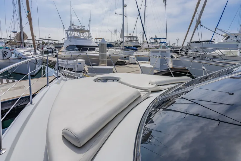 Slide: The Image of 2003 Bluewater Yachts Custom 6000 docked at marina, surrounded by other boats. - 21