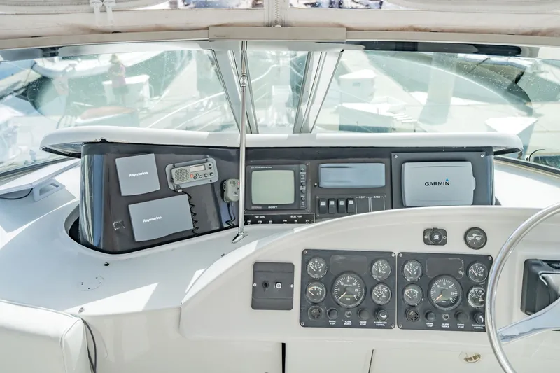 Slide: The Image of Cockpit of 2003 Bluewater Yachts Custom 6000 with navigation instruments and controls. - 76
