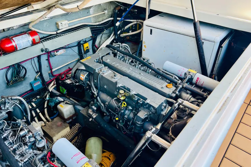 Slide: The Image of Engine compartment of a 1997 Sea Ray 330 Express Cruiser with visible machinery and wiring. - 5