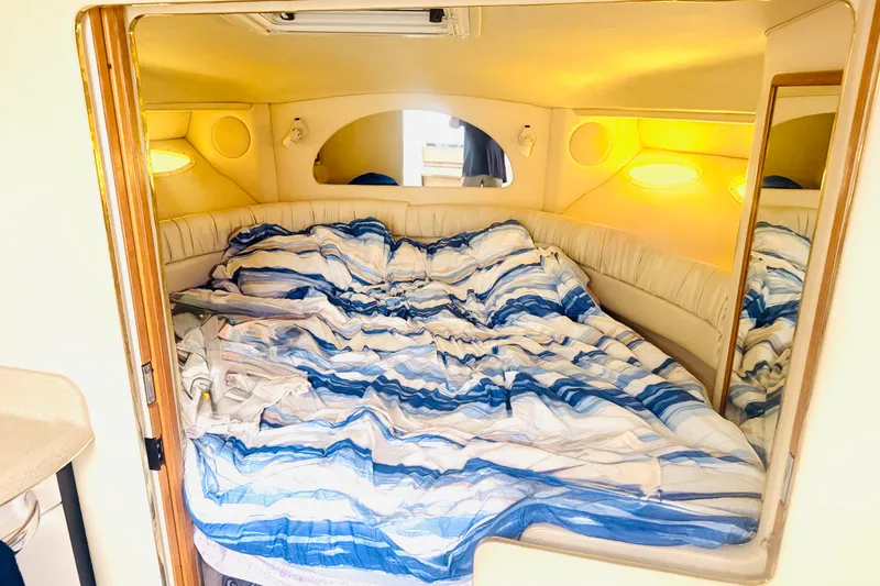 Slide: The Image of Interior cabin of 1997 Sea Ray 330 Express Cruiser with cozy bedding. - 8