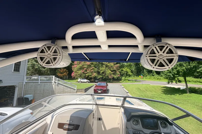 Slide: The Image of 2016 Chaparral 250 Suncoast boat interior with speakers and dashboard view. - 18
