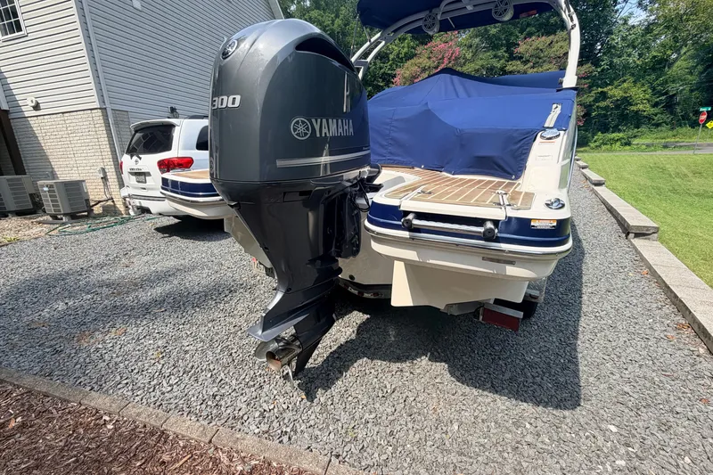 Slide: The Image of 2016 Chaparral 250 Suncoast boat with Yamaha 300 engine, parked on gravel driveway. - 5