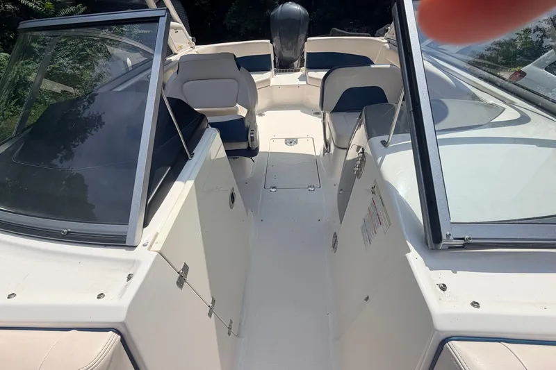 Slide: The Image of 2016 Chaparral 250 Suncoast boat interior with seating and open windshield. - 28