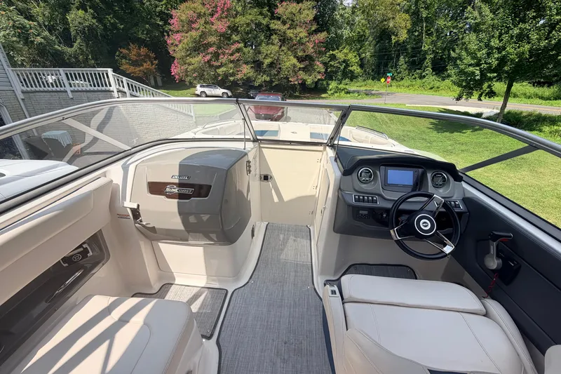 Slide: The Image of 2016 Chaparral 250 Suncoast boat interior with steering wheel and seating area. - 14