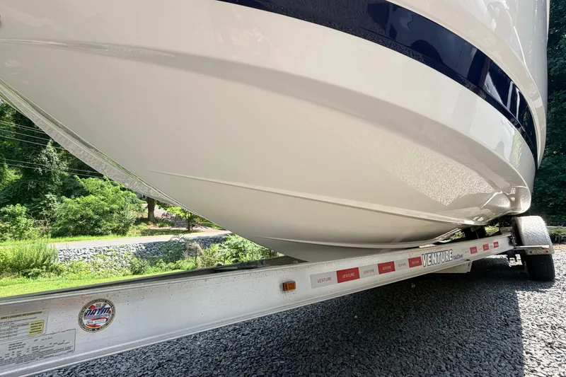 Slide: The Image of 2016 Chaparral 250 Suncoast boat on a Venture trailer, parked on gravel. - 11